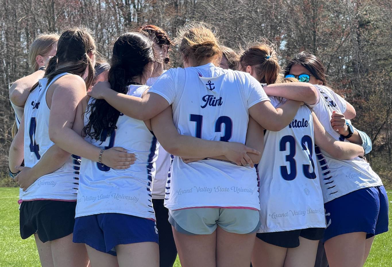 Group of women ultimate players in a team huddle